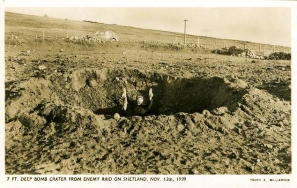 Man holding rabbit in bomb crater