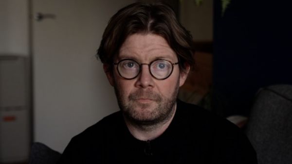 Leaseholder Lewis Ryan, a man with dark hair and glasses