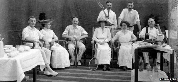 Undated photo of a group of people posing for a photograph during a tennis party at least 100 years ago