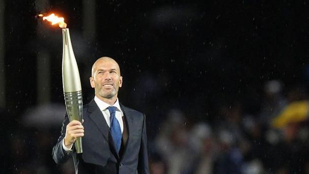 Zinedine Zidane carries the Olympic torch at the opening ceremony of the 2024 Paris Games