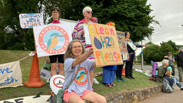 Campaigners outside Penisula House in Exeter holding placards criticising South West Water