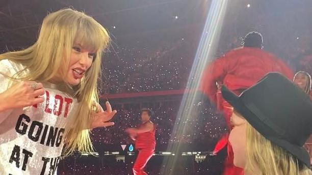 Taylor Swift with seven-year-old fan who she gave her hat to