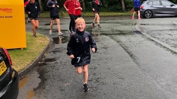 Oscar running as he fundraises to get defibrillators in his local club