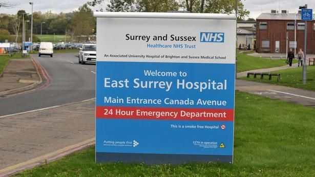 The 'Welcome to East Surrey Hospital' sign at the front of the hospital complex