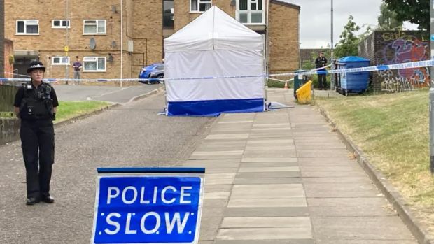 Police forensic tent, police slow sign and police officers in Paragon Place