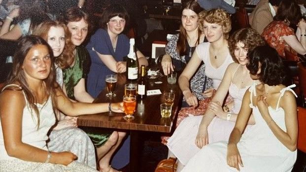 A group of women around a table with drinks in 1978