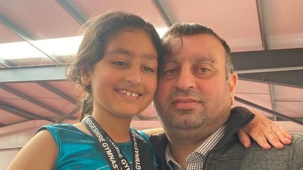 Zoya and her father at a gymnastics meet