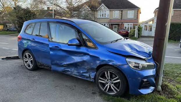 Blue car crashed into a telegraph pole