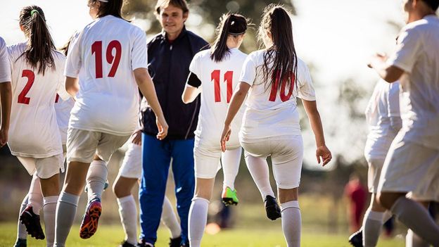 Girls playing football