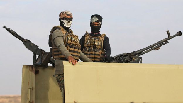 File photo showing Iraqi paramilitary fighters standing guard near the Iraq-Syria border on 11 November 2018