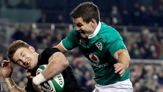 Johnny Sexton tries to prevent Beauden Barrett in Ireland's game against New Zealand on 18 November
