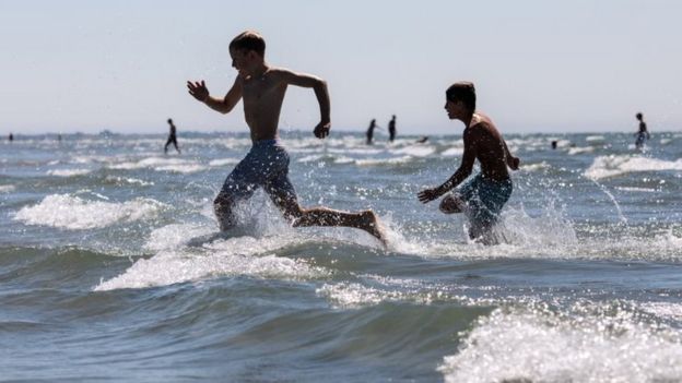 People in the sea in West Wittering Beach