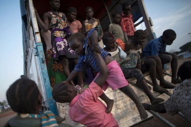 South Sudanese refugee families disembark a bus at the Kuluba Collection Point after being brought from the border on February 24, 2017 in Kuluba, Uganda.