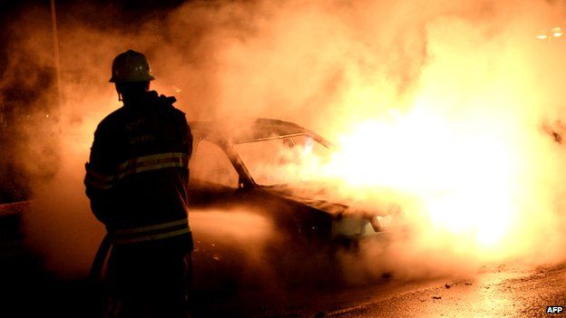 A car burns during riots in the Stockholm suburb of Kista in May 2013