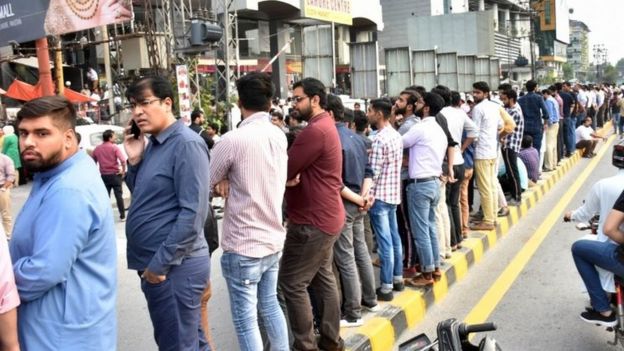 Peoplegather outside offices and shops in Mirpur, Pakistan-administered Kashmir. Photo: 24 September 2019