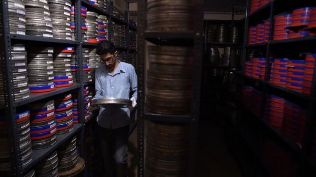 An employee taking a film reel to be digitised at the state-run Afghan Film department in Kabul