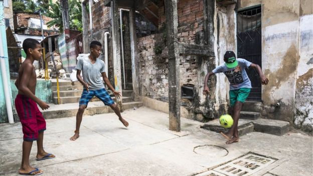 Boys playing football on the streets of Salvador