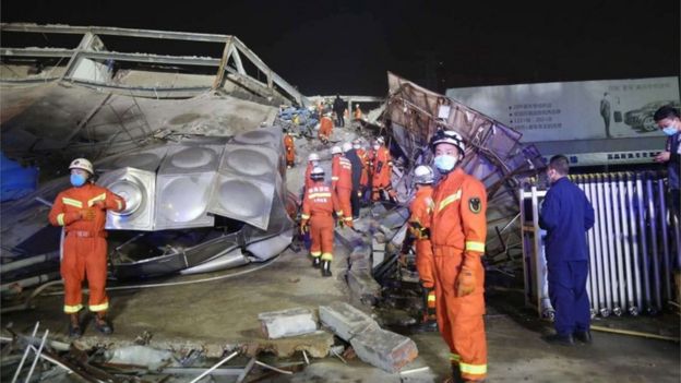 Rescuers work at the site of a collapsed five-story hotel building in Quanzhou city in southeast China's Fujian province, 07 March 2020.