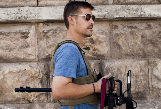 James Foley holding his camera
