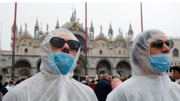 Tourists wear protective face masks at Venice Carnival