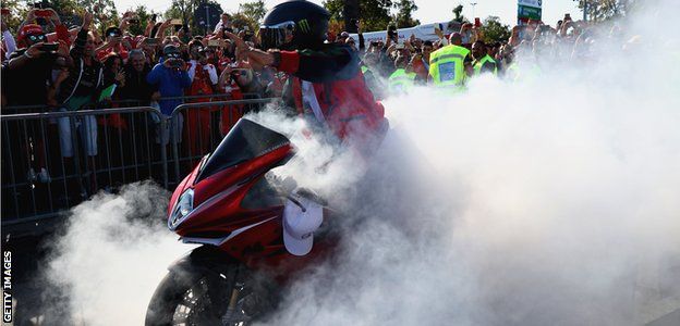Lewis Hamilton arrives at Monza on a motorbike