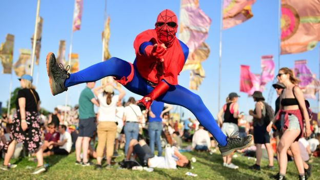 A man dressed as spider-man at Glastonbury