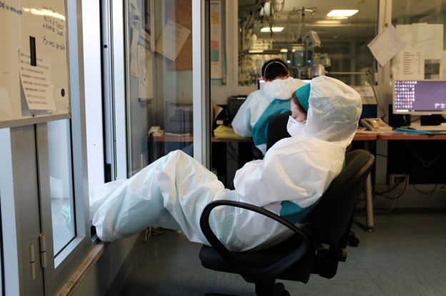 A member of hospital staff relaxes on a chair