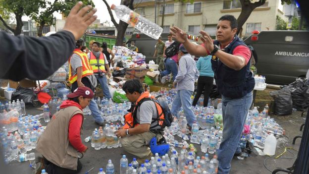 Voluntarios distribuyen agua y productos de primera necesidad.