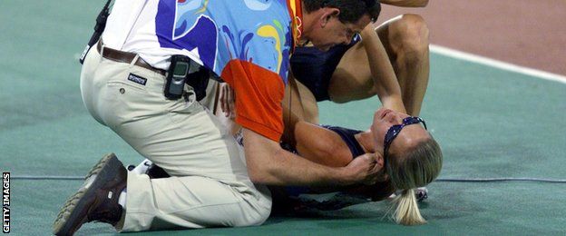 Suzy Hamilton is attended to after falling during the 1500m final at the Sydney Olympics, something she admits was intentional