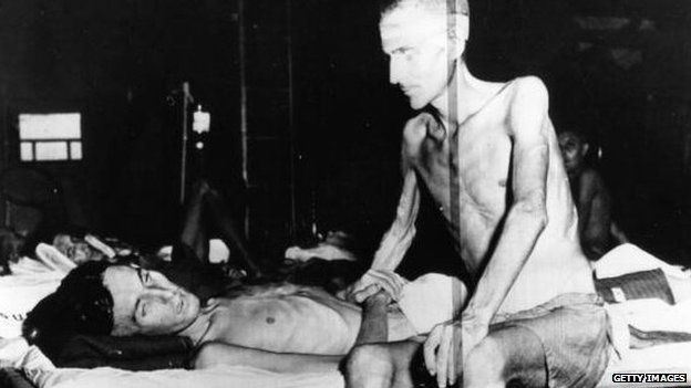 Two emaciated prisoners of war after being rescued from a Japanese POW Camp