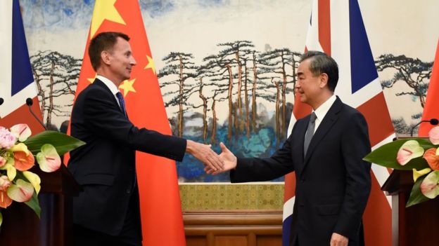 Britain's Foreign Secretary Jeremy Hunt (L) shakes hands with China's Foreign Minister Wang Yi (R) after a press conference at the Diaoyutai State Guesthouse in Beijing on July 30, 2018