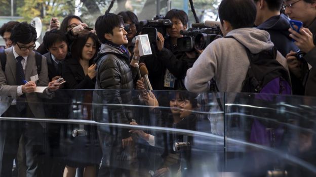 The first customer to the Apple Omotesando store holds a box containing his iPhone X as he speaks to the media on November 3, 2017 in Tokyo, Japan.