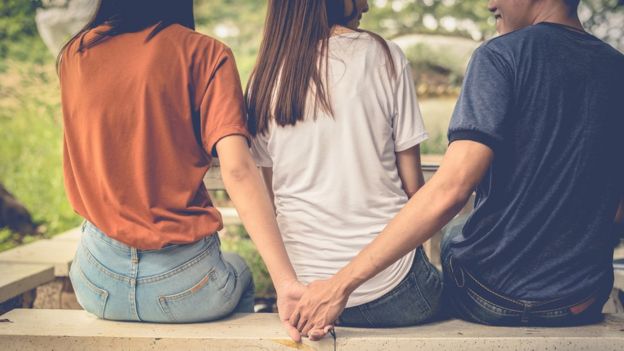 three people on a bench