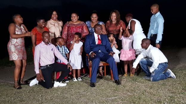 The whole Mseleku family including children pose for a photo in their garden