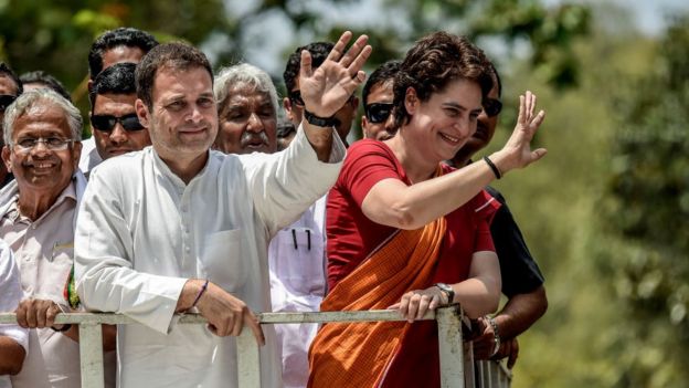 Rahul Gandhi and Priyanka Gandhi wave at the crowd in the road show after Rahul Gandhi filing nominations from Wayanad district on April 4, 2019 in Kalpetta town in Wayanand, India.