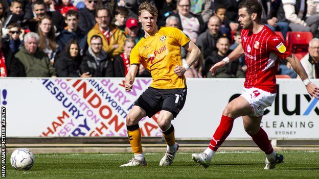 Newport County's Rob Street competes with Dion Conroy of Swindon Town