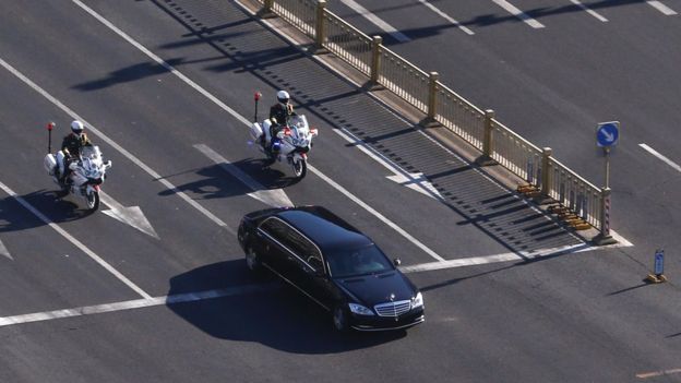 A vehicle that is part of a motorcade that is believed to be carrying North Korean leader Kim Jong Un makes its way through central Beijing