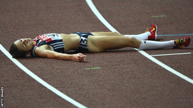 An exhausted Jo Pavey lies on the track in Osaka