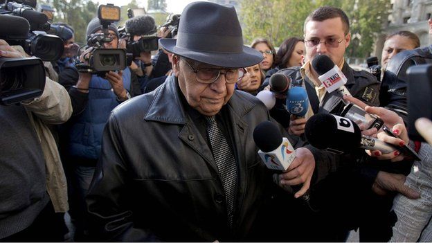 Ion Ficior surrounded by journalists after he was charged in 2013 (file picture)