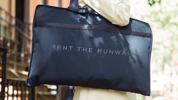 Una mujer lleva una bolsa con el logo de Rent the Runway