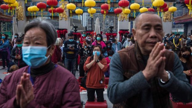 In Hong Kong's Wong Tai Sin temple, people welcome the new year in masks