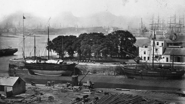 1866: Looking west from Trinity Wharf; the terminal of the Blackwall Railway is in the distance on the right. The masts in the distance on the left are in the West India docks on the Isle of Dogs