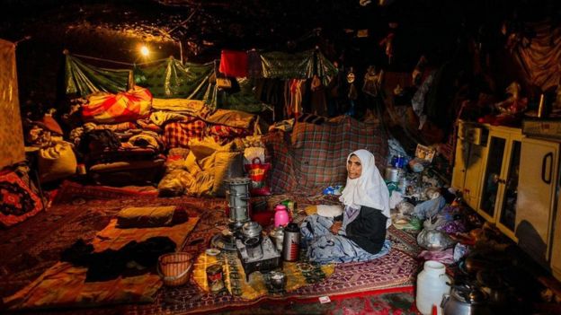 سيدة تجلس في منزلها في كهف في قرية ميمند الإيرانية