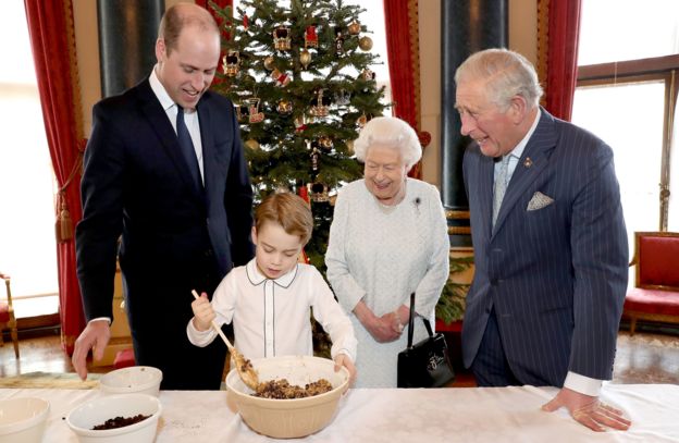 Queen Elizabeth II, the Prince of Wales, the Duke of Cambridge and Prince George preparing special Christmas puddings in the Music Room at Buckingham Palace, London, as part of the launch of the Royal British Legion's Together at Christmas initiative