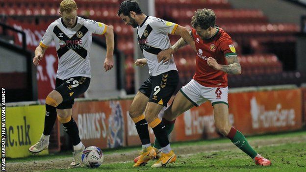 Newport's Padraig Amond and Mickey Demetriou in action against Dan Scarr of Walsall