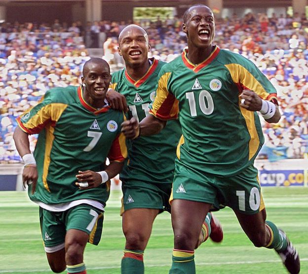 Senegalese defender Khalilou Fadiga (R) celebrates his goal from a penalty kick with teammates Henri Camara (L-#7) and El Hadj Diouf (C) in their Group A match against Uruguay at the 2002 FIFA World Cup Korea/Japan in Suwon, 11 June 2002.