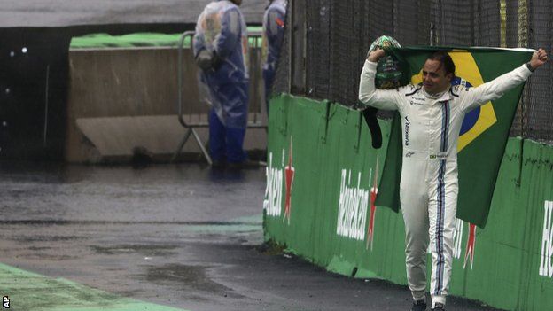 Massa walks down the pit lane