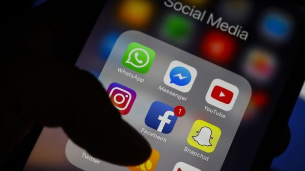 Imagem mostra dedo tocando tela de smartphone, em que aparecem ícones de redes sociais
