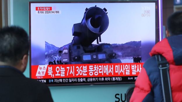 Television news coverage showing archive footage of a North Korean missile launch is broadcast on a public screen in Seoul on March 6, 2017.