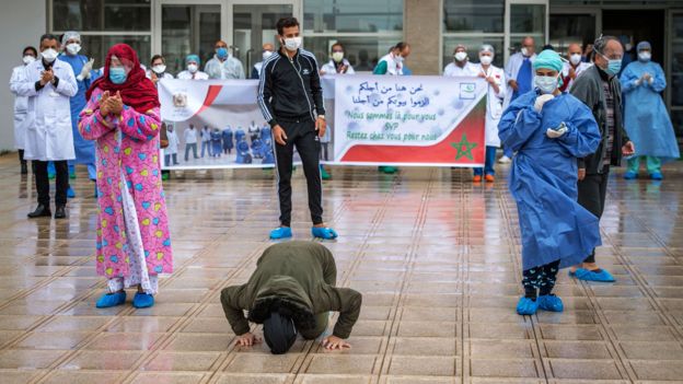 Un paciente de covid-19 besa el suelo tras abandonar el hospital en Marruecos.